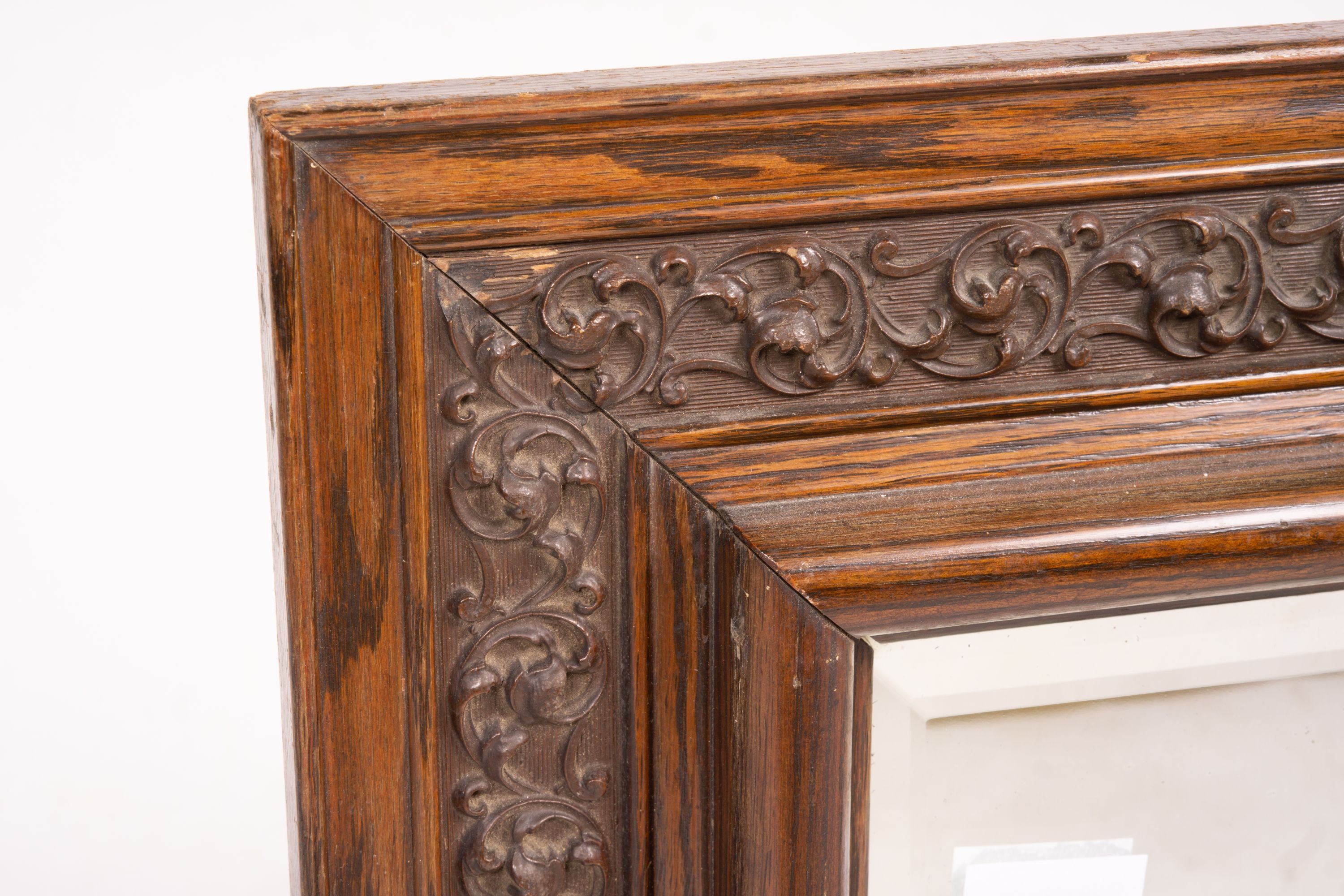 An early 20th century carved oak rectangular wall mirror, width 57cm, height 64cm